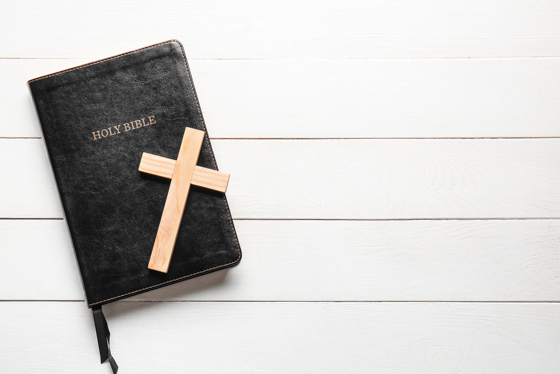 Holy Bible and Cross on White Wooden Background